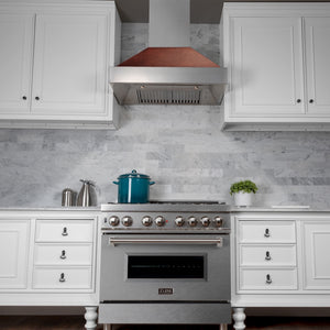 ZLINE Ducted Satin Stainless Steel Wall Mount Range Hood with Hand-Hammered Copper Shell and Size Options (8654HH) in a kitchen with gray marble countertop