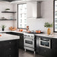 ZLINE Ducted Vent Wall Mount Range Hood in Stainless Steel with Built-in ZLINE CrownSound Bluetooth Speakers (KN4CRN-BT) side, in a luxury modern-style kitchen with matching appliances.