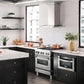 ZLINE Ducted Vent Wall Mount Range Hood in Stainless Steel with Built-in ZLINE CrownSound Bluetooth Speakers (KN4CRN-BT) side, in a luxury modern-style kitchen with matching appliances.