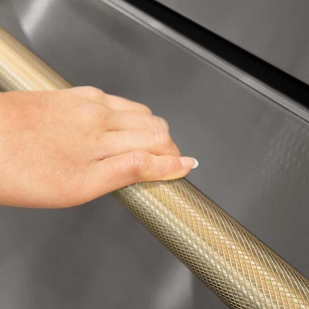 ZLINE Autograph Edition 36 in. 21.6 cu. ft. Counter-Depth French Door Refrigerator with Water and Ice Dispenser in Fingerprint-Resistant Stainless Steel with Champagne Bronze Helix Handles (RFMZ-W-36-KCB) hand holding Helix handle showing knurled diamond texture.