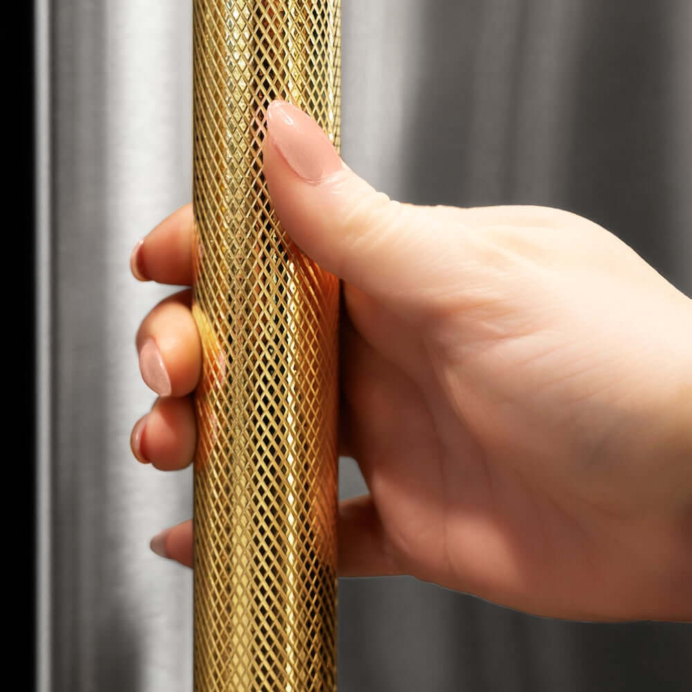 ZLINE Autograph Edition 60 in. 32.2 cu. ft. French Door Built-In Bottom Freezer Refrigerator with Water Dispenser and Ice Maker in Stainless Steel with Graphite Gray Interior and Polished Gold Helix Handles (GRBIVZ-30460KG) hand holding Helix handle showing knurled diamond texture.