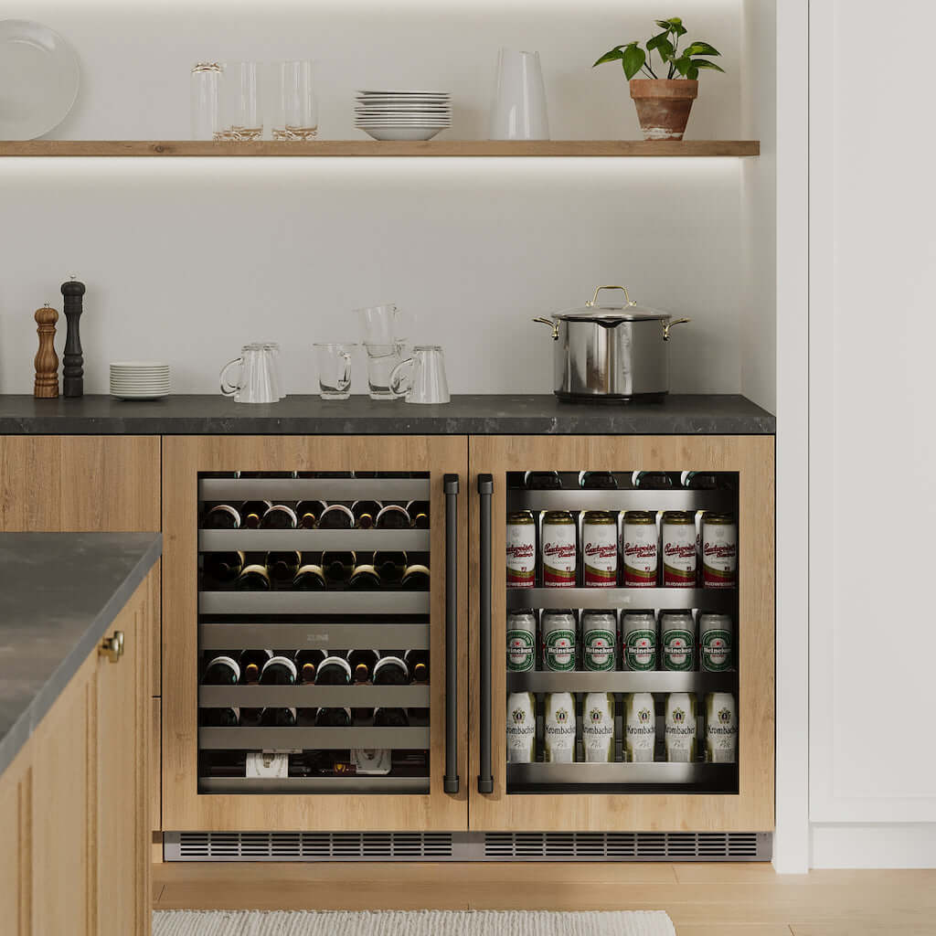 ZLINE Touchstone Under Counter Dual Zone Wine Cooler and Beverage Fridge side-by-side under dark countertop with wooden cabinetry in a luxury kitchen.