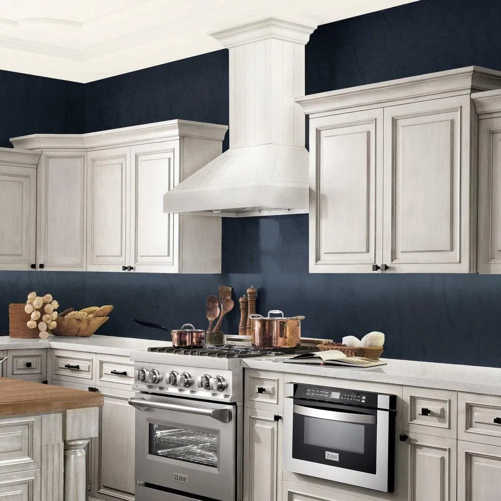 ZLINE Wooden Wall Mount Range Hood in Cottage White - Includes Motor (KPTT) side, in a luxury cottage-style kitchen with matching appliances.
