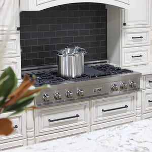 ZLINE 48 in. Legacy Gas Rangetop with 7 Burners and Porcelain Cooktop in Satin Stainless Steel (RTS-48) in a kitchen with black tiled backsplash and white cabinets.