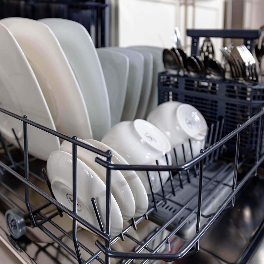 Dishes and utensils in BREDA dishwasher.