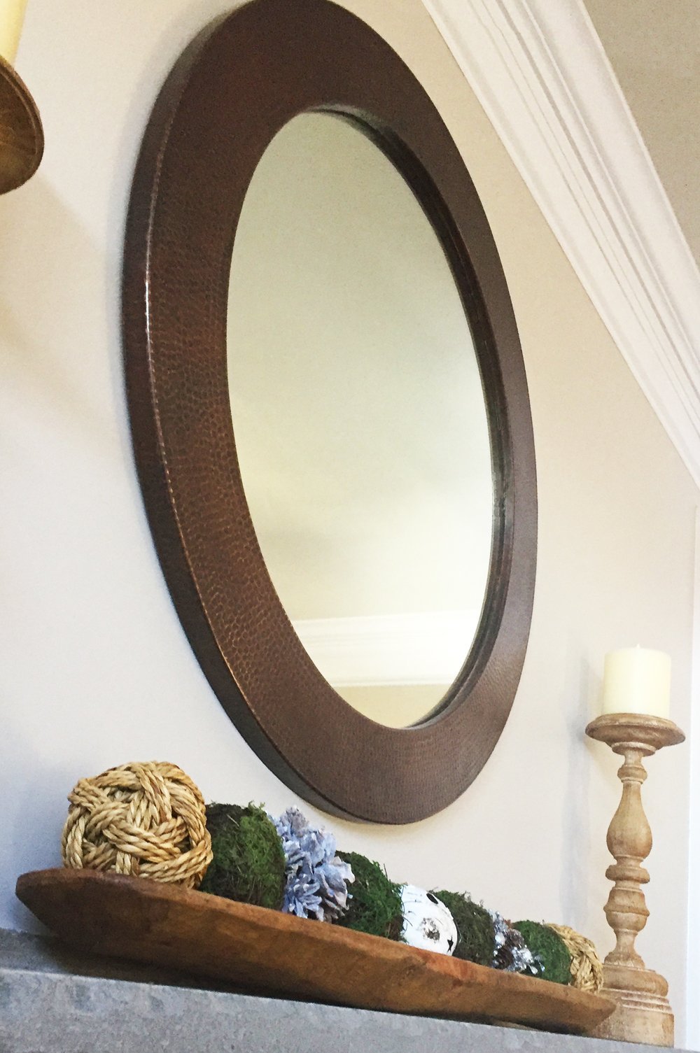 34" Round Hammered Copper Mirror above a mantle in a rustic home