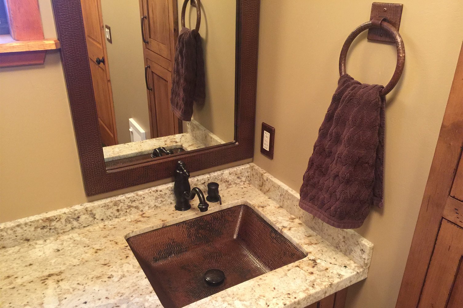 36" Rectangle Hammered Copper Mirror in a farmhouse style bathroom with matching sink