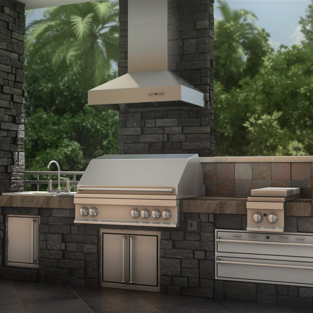 ZLINE Outdoor Wall Mount Range Hood in Outdoor Approved Stainless Steel (667-304) rendering outside above a barbecue in an outdoor kitchen.
