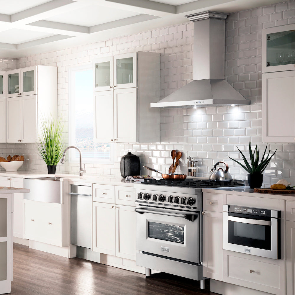 ZLINE stainless steel range, range hood, microwave, sink, faucet, and dishwasher in a luxury cottage-style kitchen.