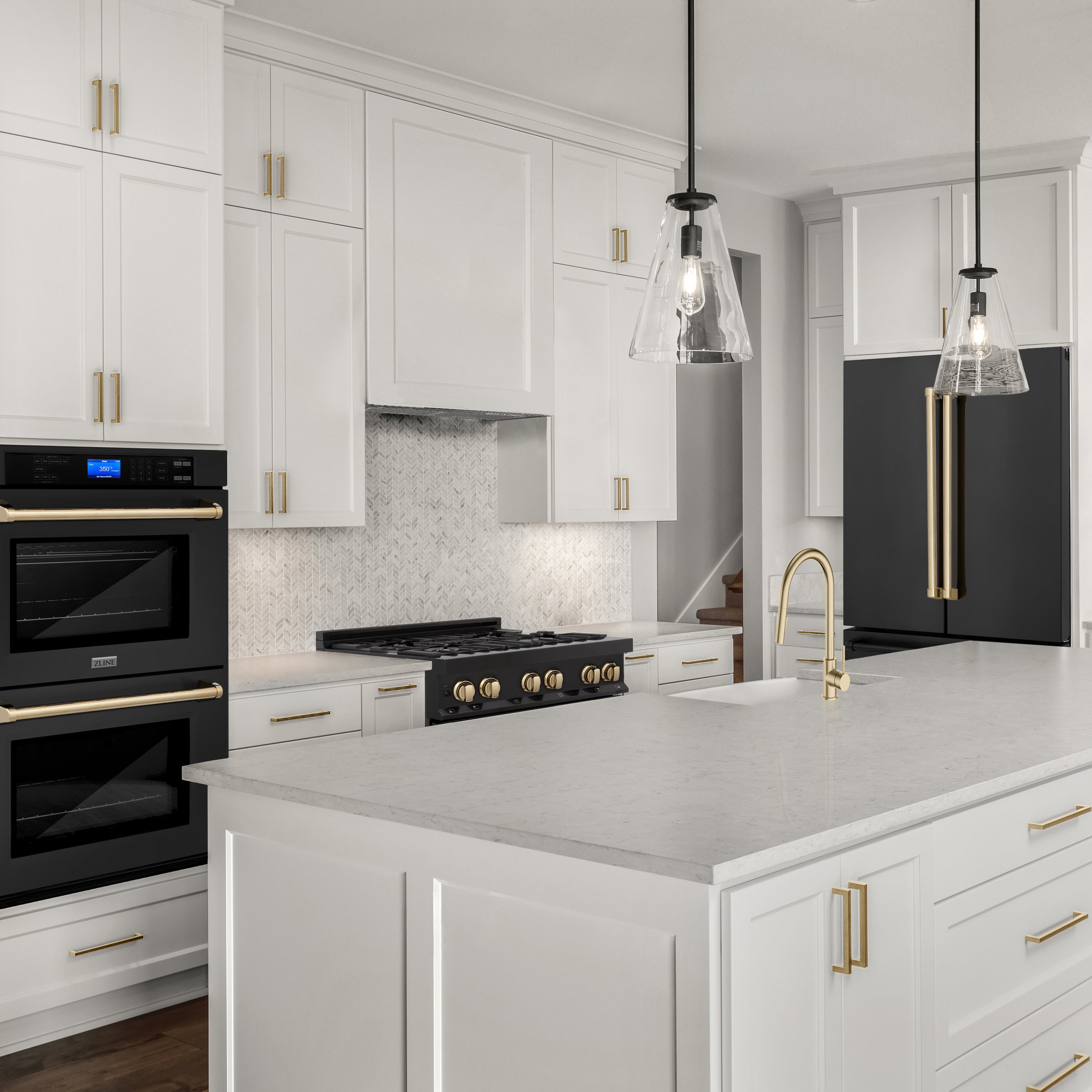 Black stainless steel kitchen appliances with gold accent handles and knobs in a white luxury kitchen with white marble counters.