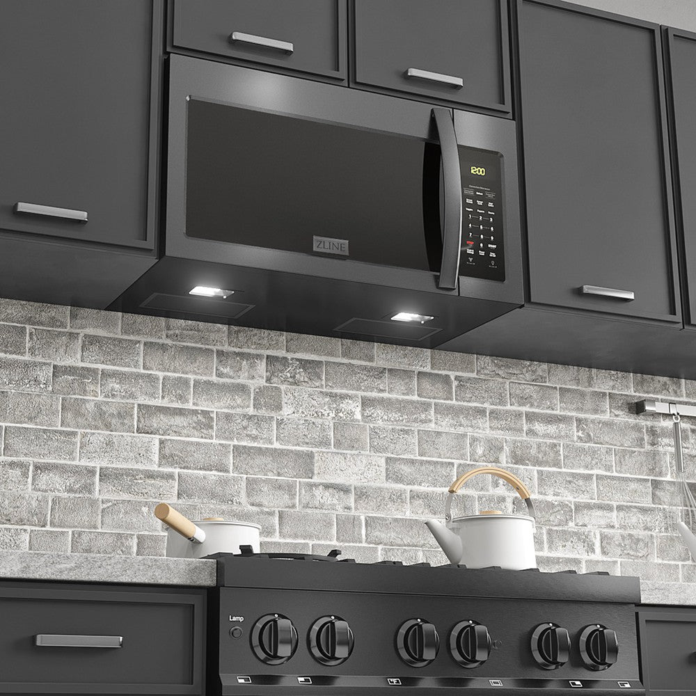 ZLINE Black Stainless Steel Over the Range Microwave in a modern kitchen above cooktop with lighting on.