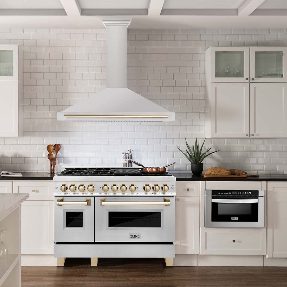 ZLINE 48 inch range and range hood with polished gold accents in a white farmhouse kitchen