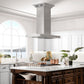 ZLINE Island Mount Range Hood in Stainless Steel with Built-in ZLINE CrownSound Bluetooth Speakers (KE2iCRN-BT) in a farmhouse-style kitchen.