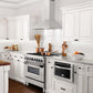 ZLINE kitchen appliances in luxury farmhouse kitchen with white cabinets and countertops
