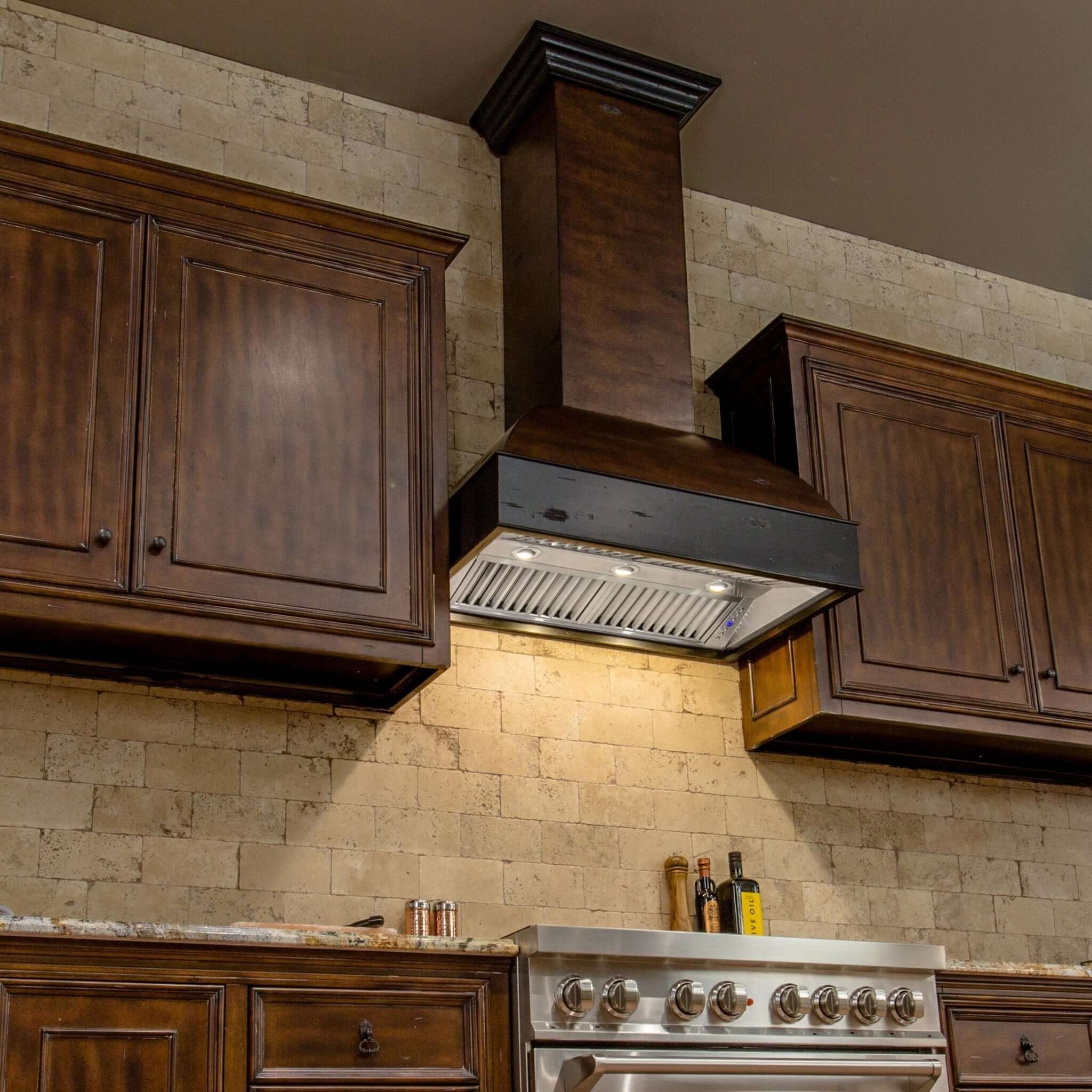 ZLINE 36 in. Wooden Wall Mount Range Hood in Antigua and Walnut (369AW-36) in a rustic kitchen with matching cabinets.