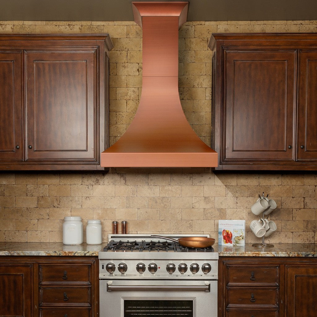 ZLINE Designer Series Copper Finish Wall Range Hood (8632C) in a rustic-style kitchen from front.