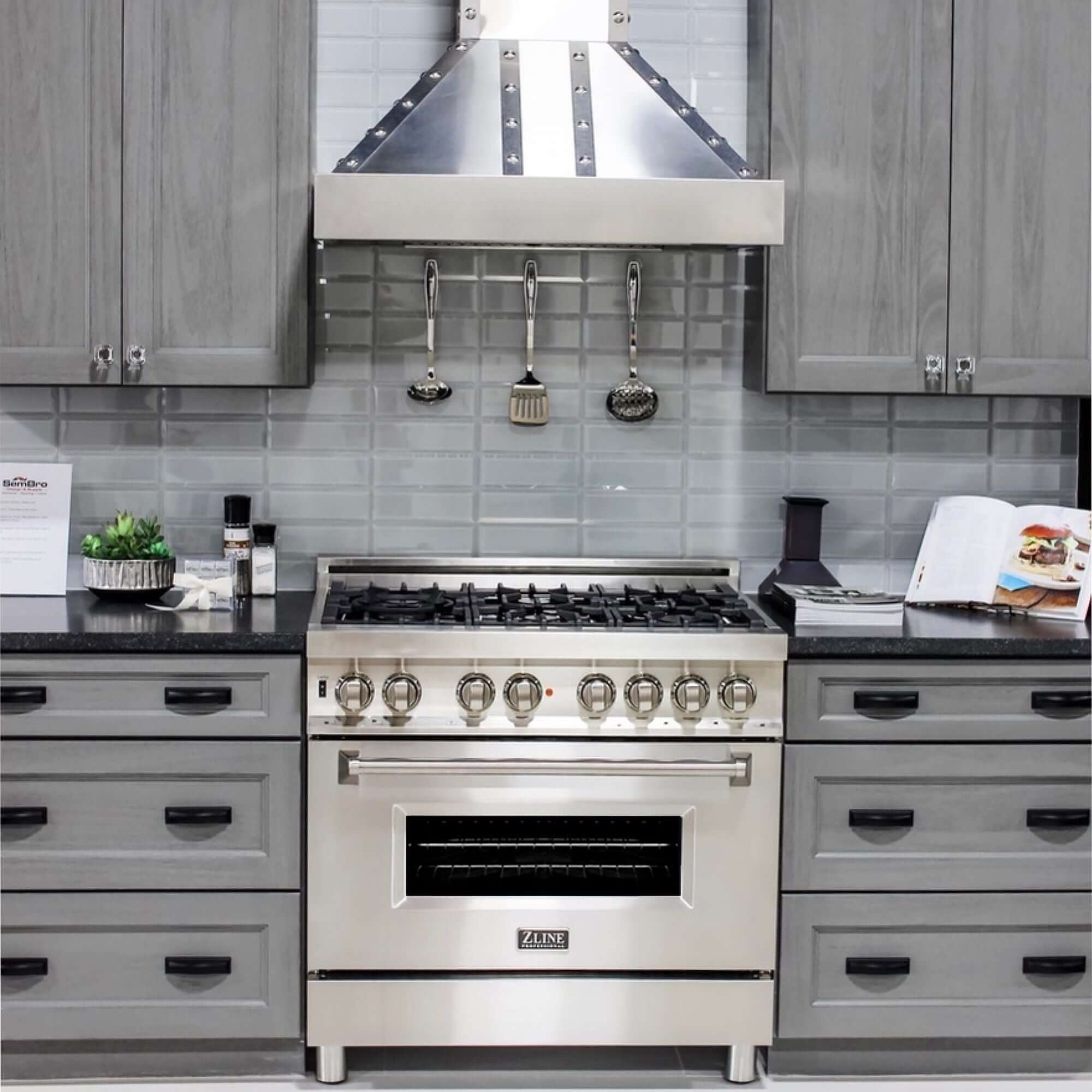 ZLINE Designer Series Wall Mount Range Hood in DuraSnow Stainless Steel with Nailhead Rivets (655-4SSSS) in a modern luxury kitchen.