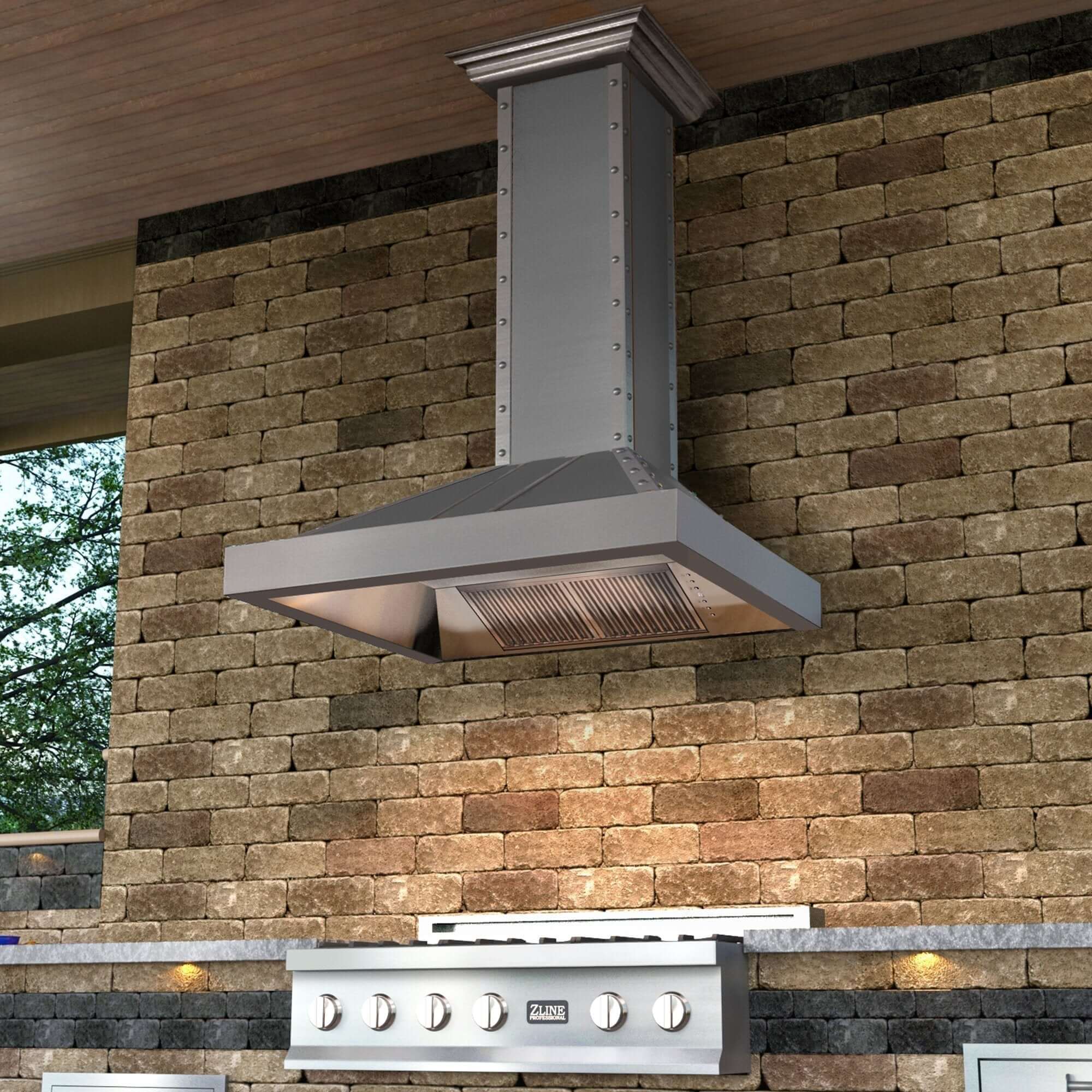 ZLINE Designer Series Wall Mount Range Hood in DuraSnow Stainless Steel with Nailhead Rivets (655-4SSSS) above and outdoor cooktop.