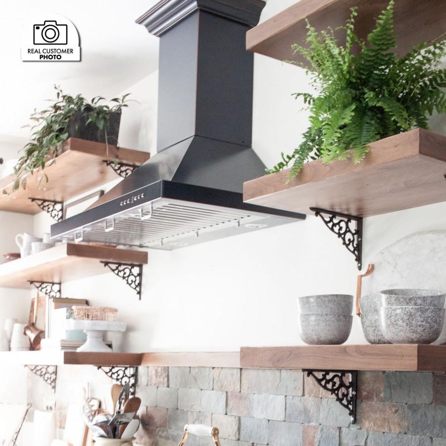 ZLINE Designer Series Oil-Rubbed Bronze Wall Mount Range Hood (8KBB) installed in a cottage-style kitchen.