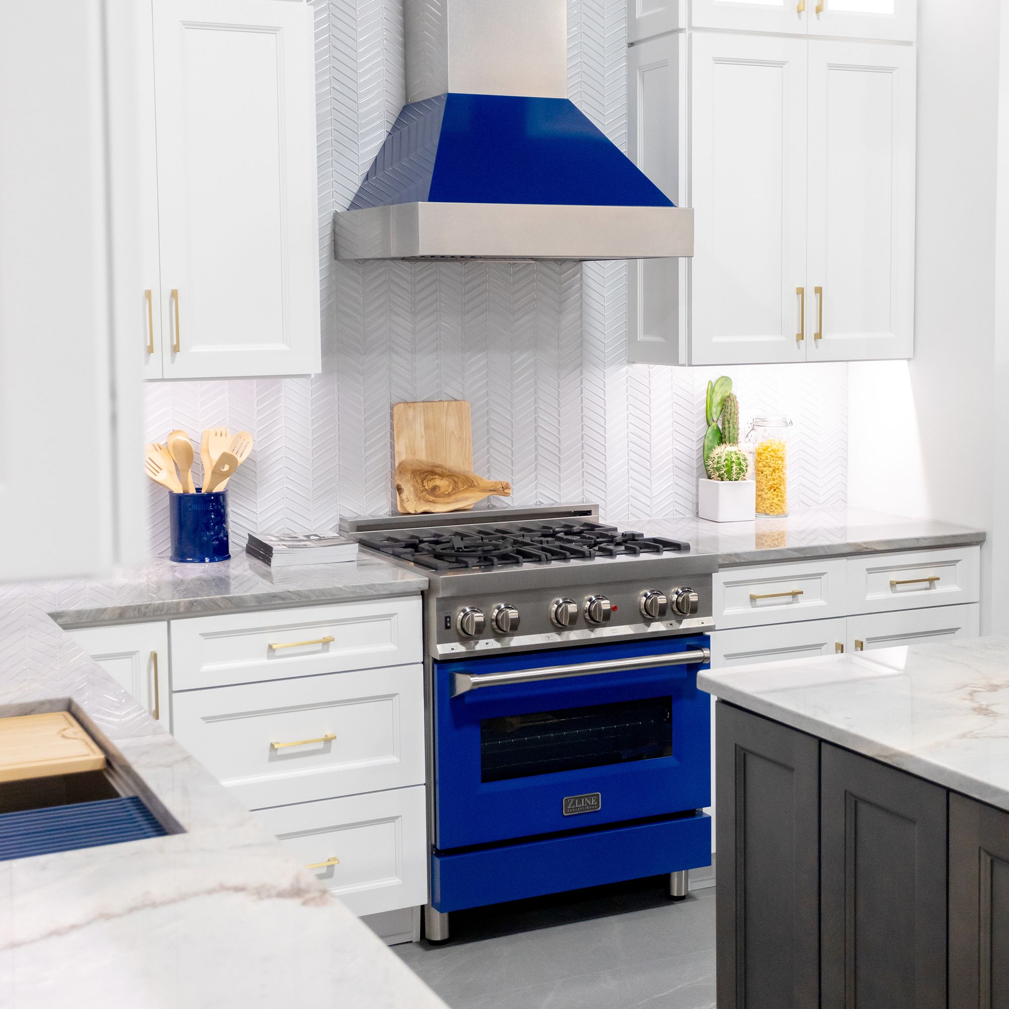ZLINE Ducted Fingerprint Resistant Stainless Steel Range Hood with Blue Gloss Shell (8654BG) with matching blue gloss range in a white cottage-style kitchen from front.