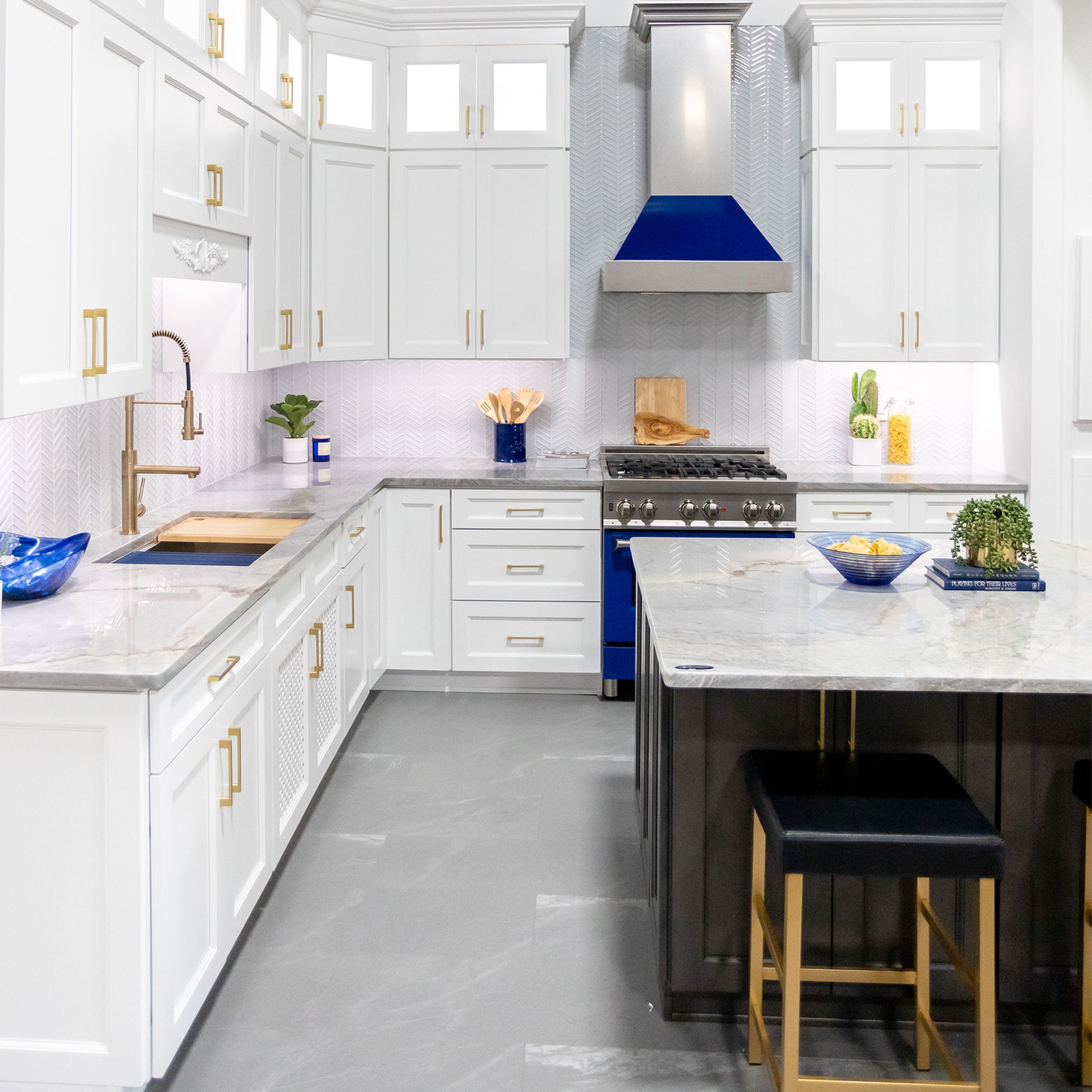ZLINE Ducted Fingerprint Resistant Stainless Steel Range Hood with Blue Gloss Shell (8654BG) with matching blue gloss range in a white cottage-style kitchen from wide.