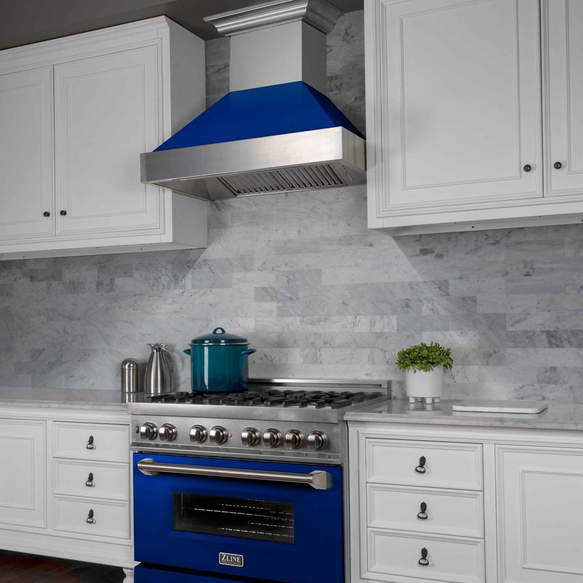 ZLINE Ducted Fingerprint Resistant Stainless Steel Range Hood with Blue Gloss Shell (8654BG) with short chimney in a kitchen with matching blue gloss range from side.