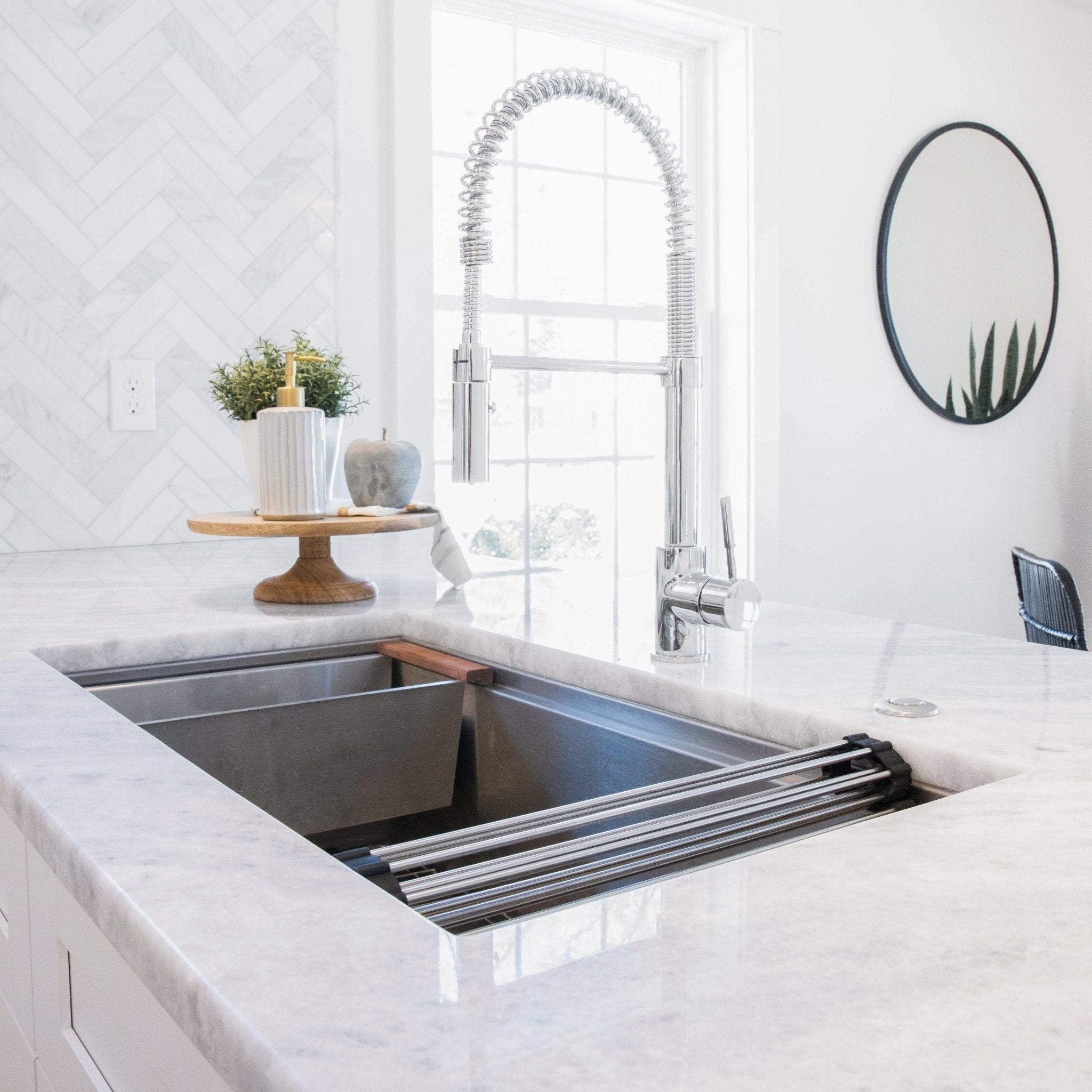 ZLINE Sierra Kitchen Faucet (SRA-KF) with Chrome Finish above farmhouse-style kitchen sink