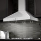 ZLINE Convertible Vent Wall Mount Range Hood in Stainless Steel with Crown Molding (KL3CRN) rendering in a rustic kitchen close-up.