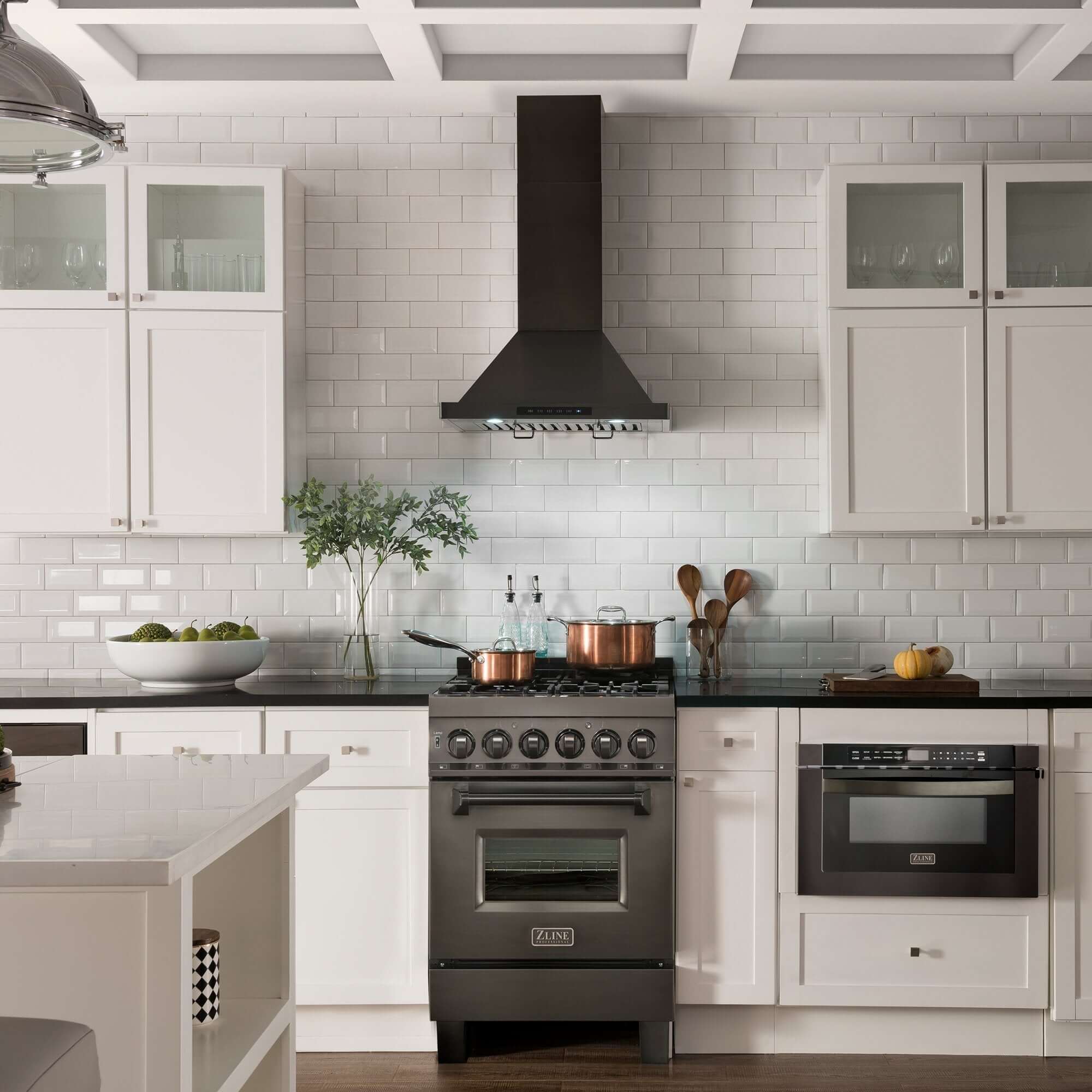 ZLINE black stainless steel wall mount range hood and range in a white farmhouse-style kitchen.