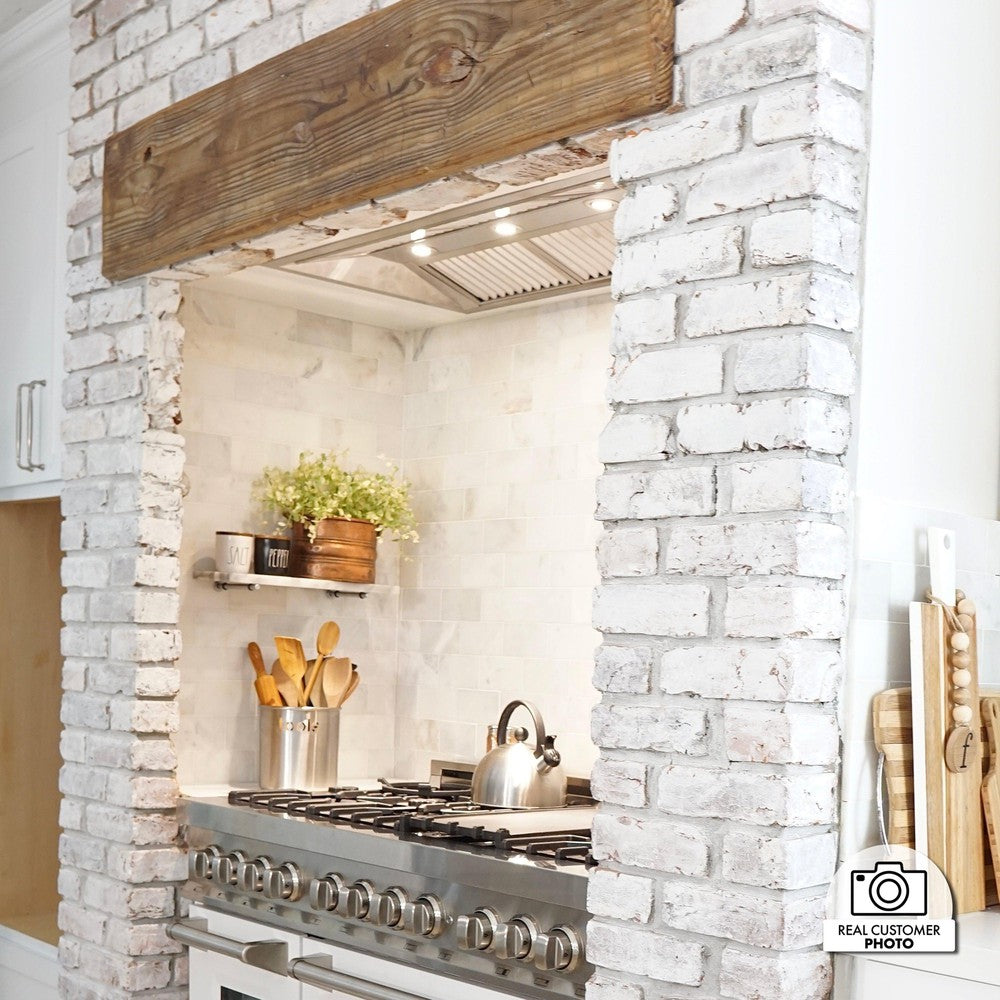 ZLINE Ducted Remote Blower 400 CFM Range Hood Insert in Stainless Steel (698-RS) in Rustic Farmhouse-Style kitchen with white brick backsplash and matching ZLINE Range